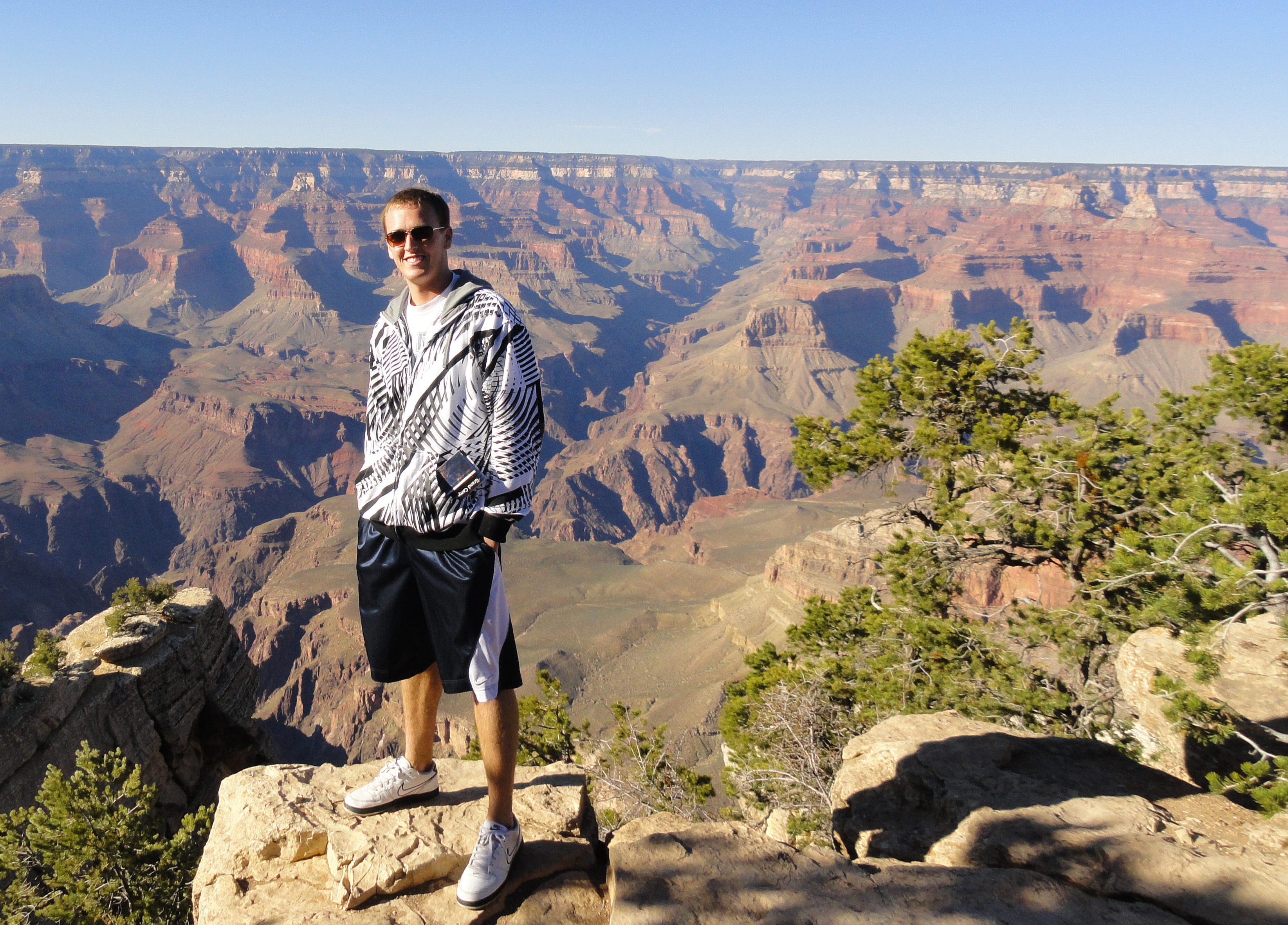 NSE student standing with the Grand Canyon behind him