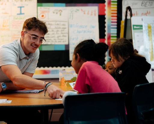 teacher working with three students