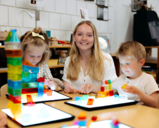 Teacher working with children in classroom.