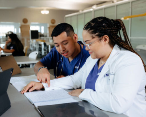 Two health care students working on project.