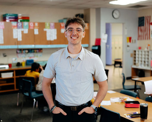 Student stating in a classroom looking directly at the camera.
