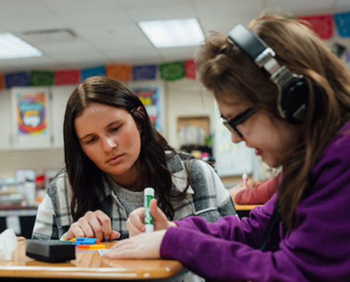Teacher working with a student.