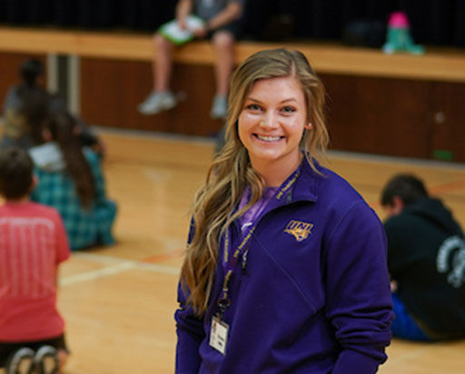PE teacher standing in a gym