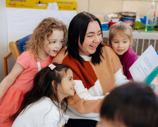 Teacher reading to young students.