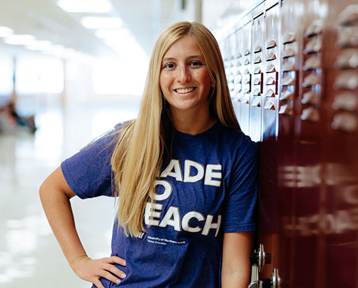 teacher standing in school hallway
