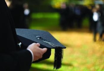 Graduate holding cap