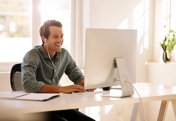 Smiling man at computer