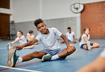 Student stretching in PE class