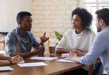 People at a table talking