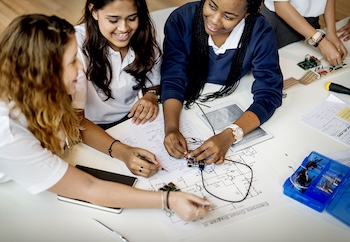 Girls working on a physics problem