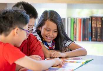 Kids looking at a book