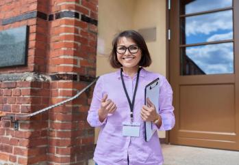 Teacher in front of school