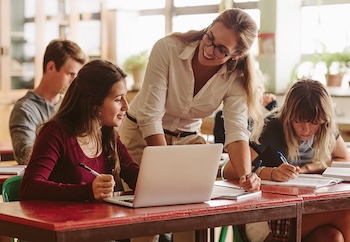 Teacher working with students in a classroom