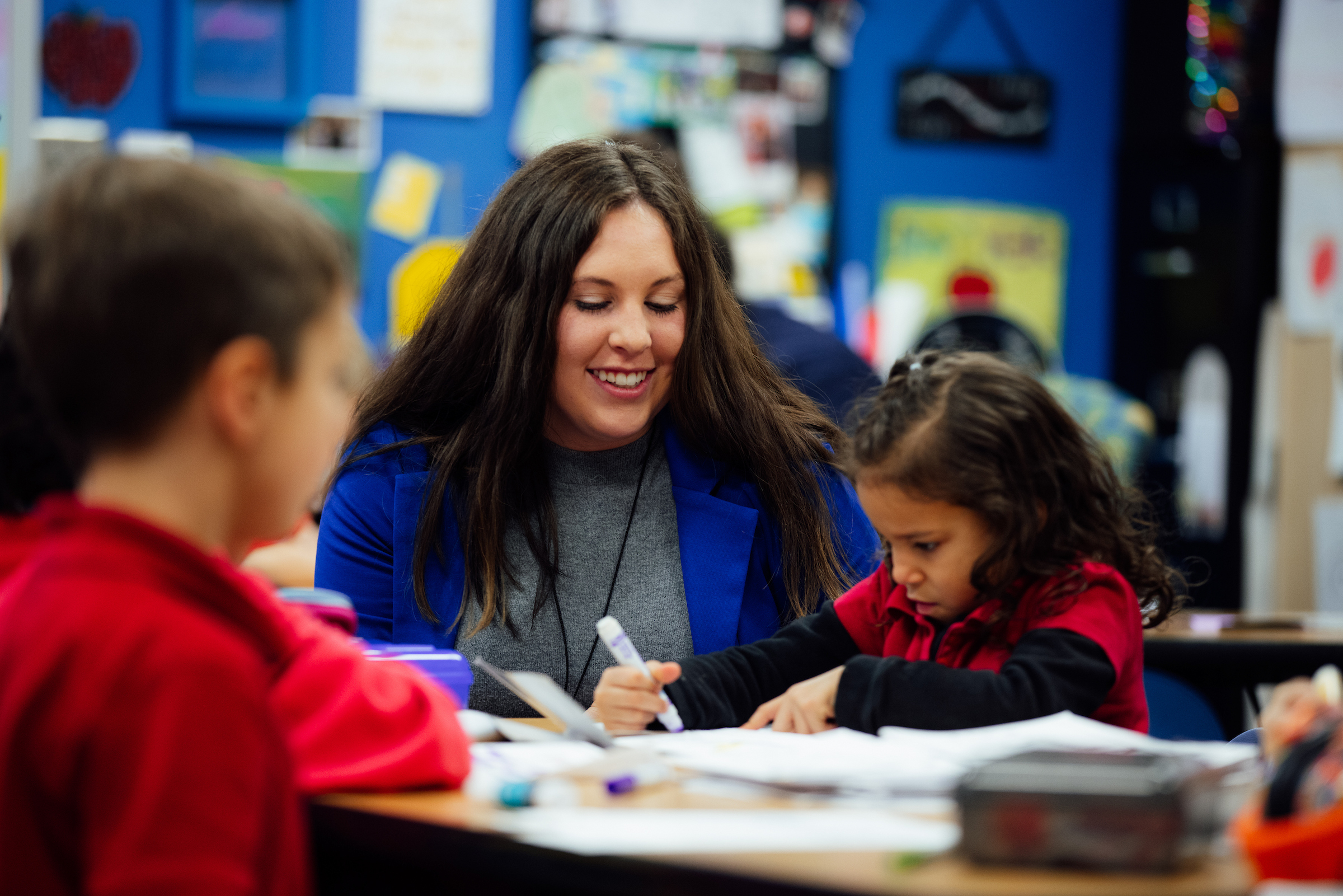 Teacher working with student.