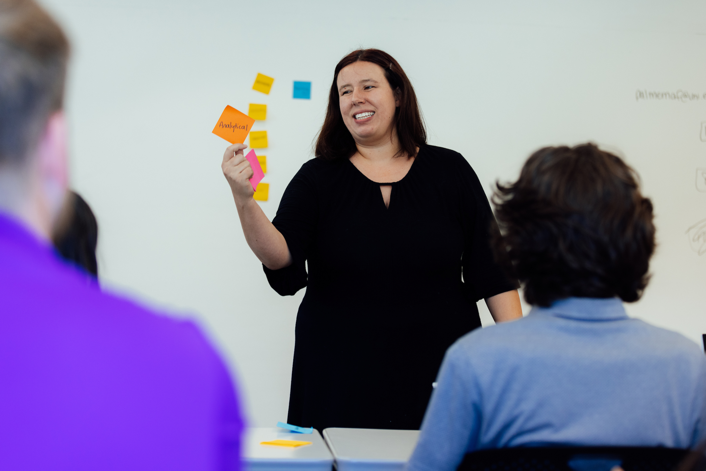 teacher talking at the front of a classroom