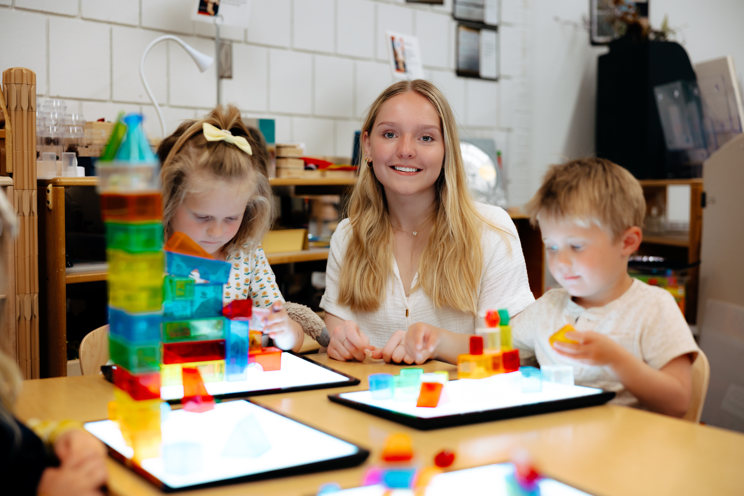 Teacher working with students in classroom.