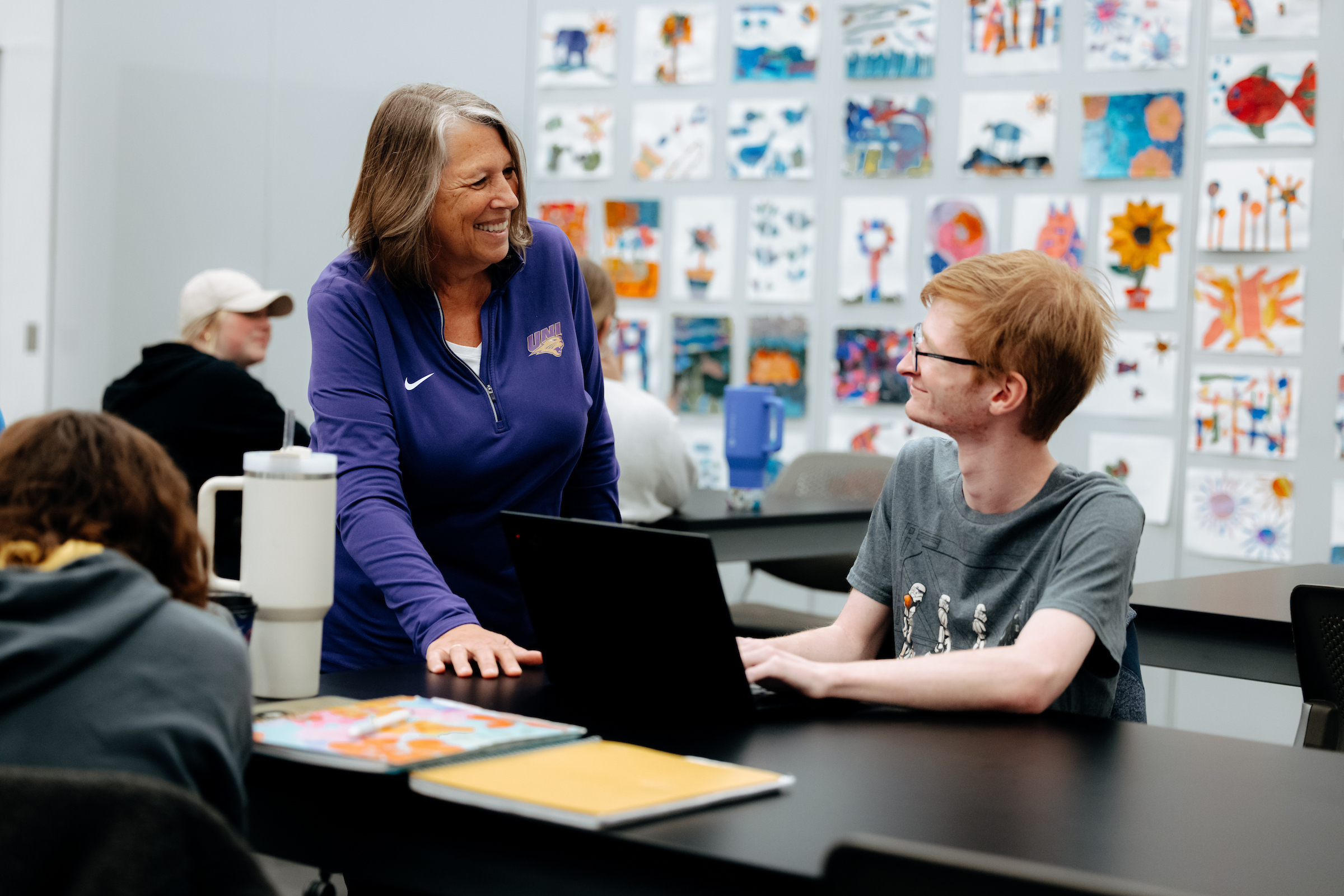 Teacher working with student. 