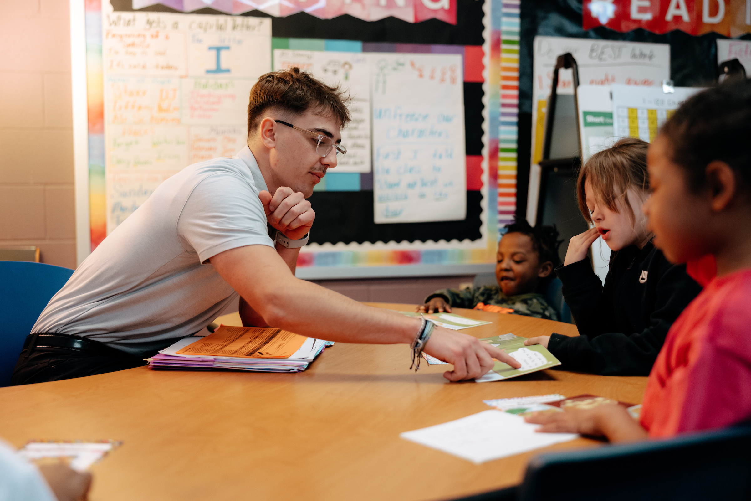 Teacher working with students in classroom.