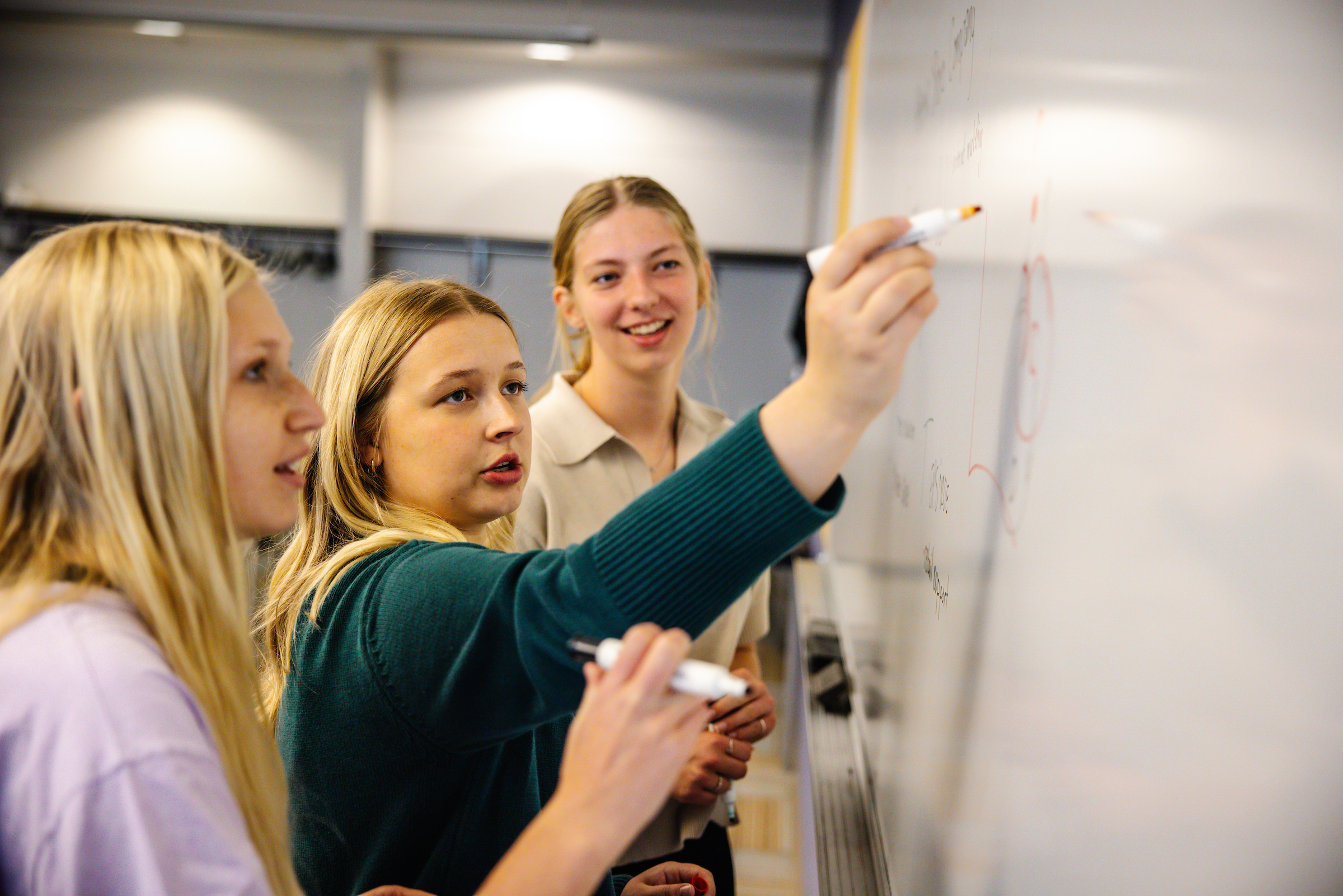 Group of students at the white board.