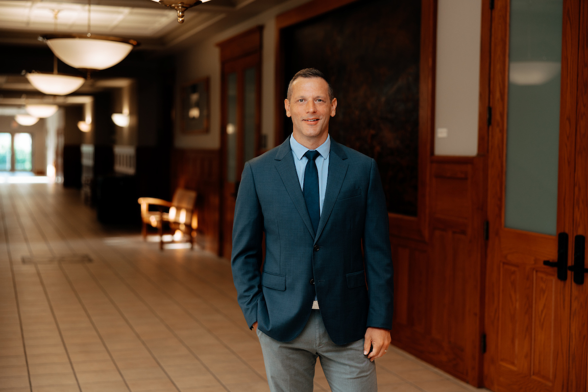 UNI Alumni Superintendent smiling in hallway 