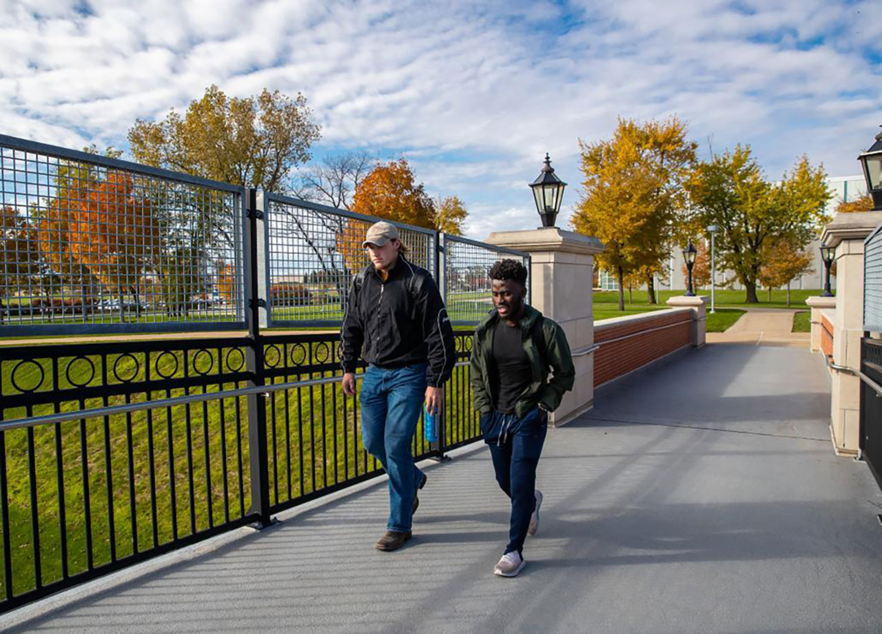 Two boys walking on campus.