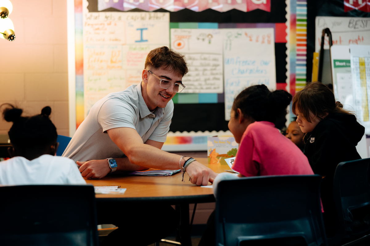 Teacher working with two students