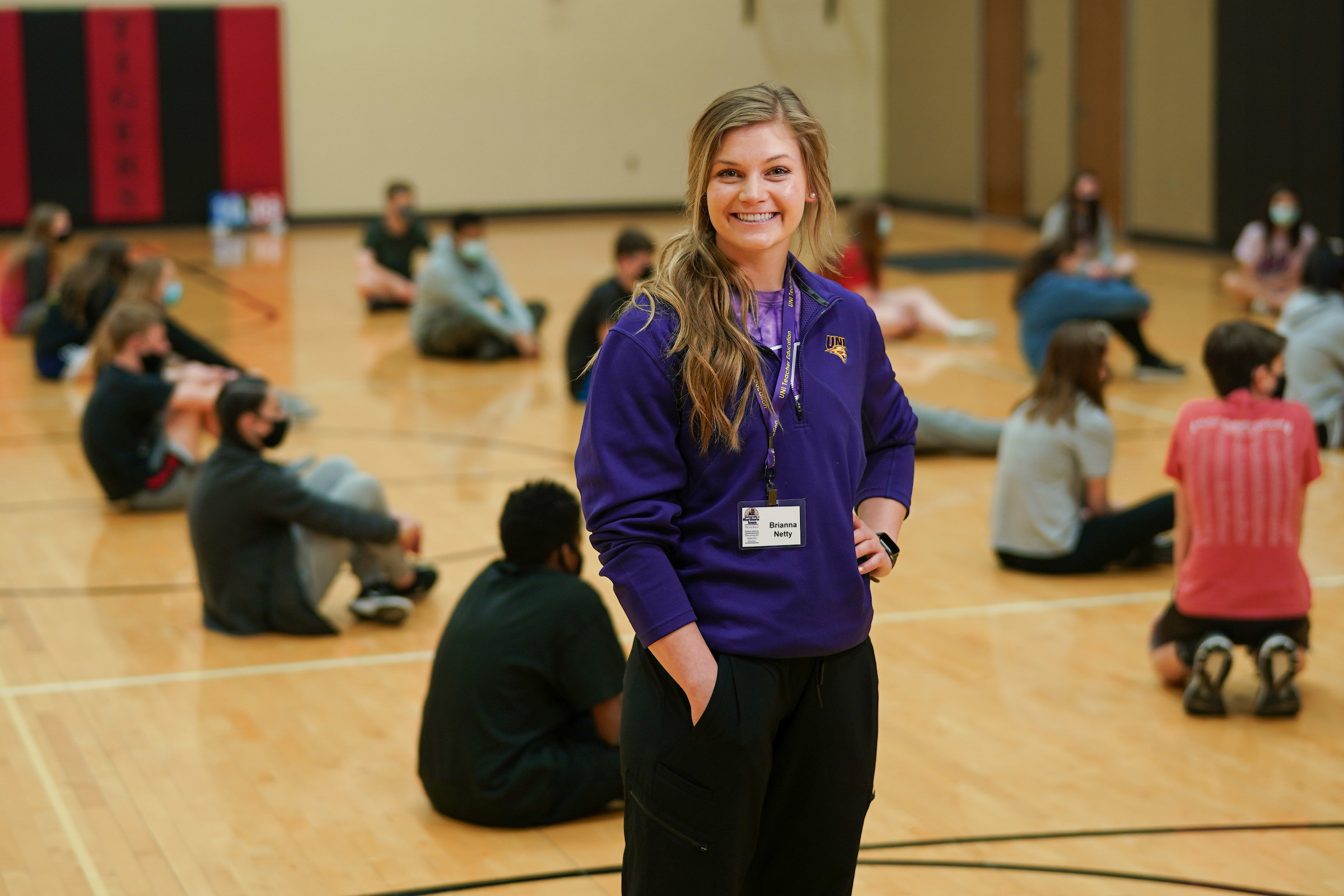Student working with PE class.