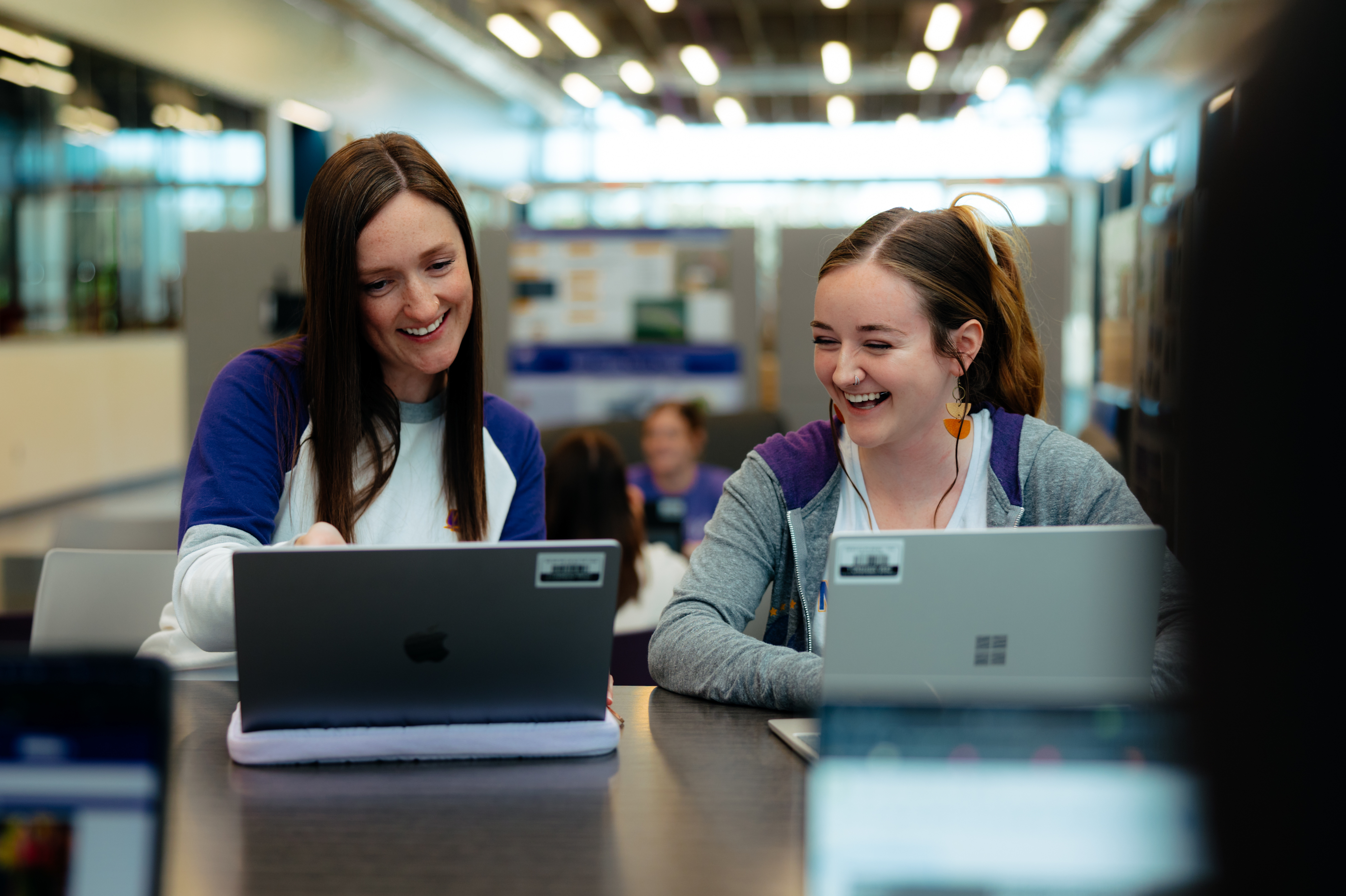 Student smiling receiving help from staff member