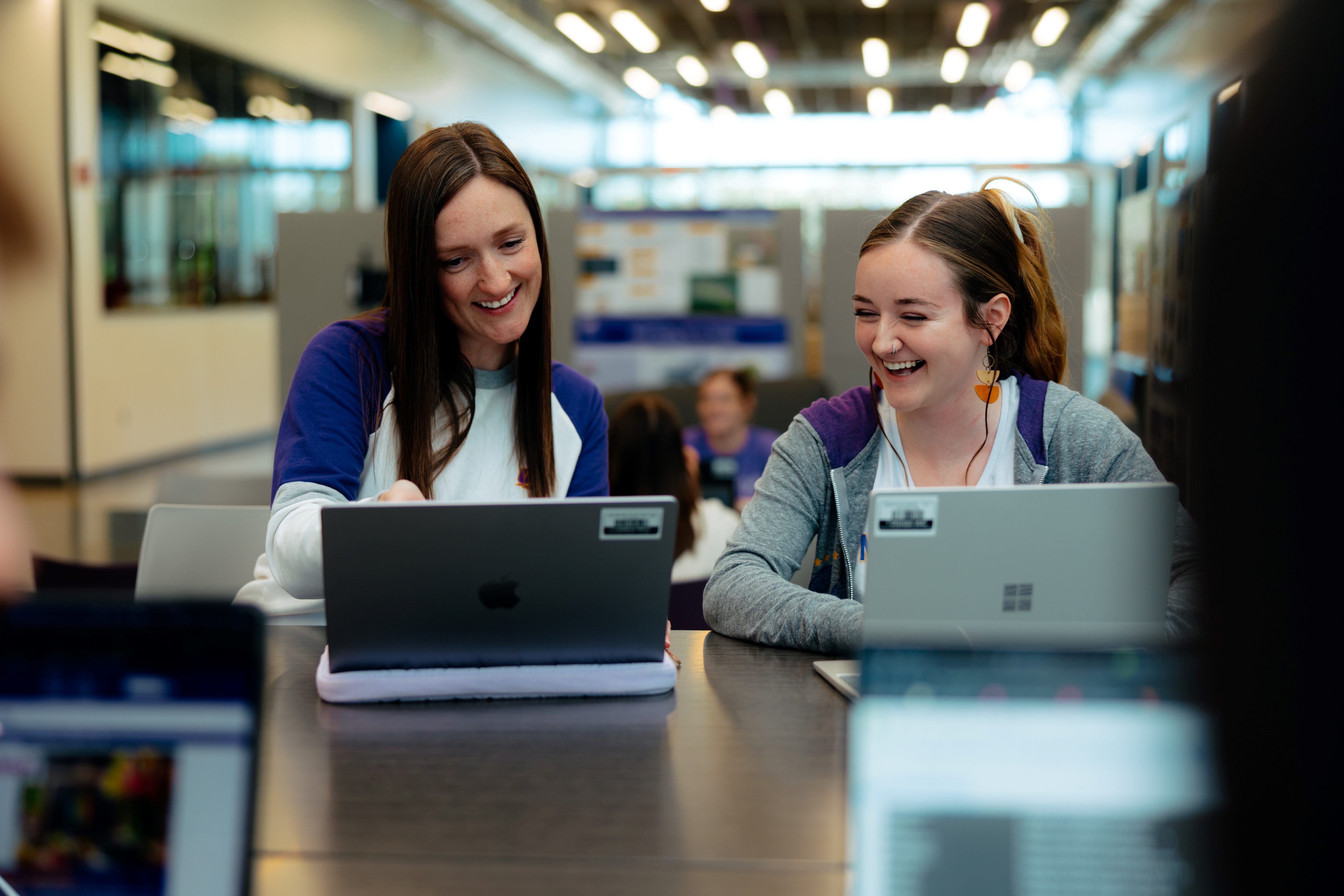 Student smiling receiving help from staff member