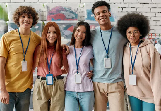 Five high school students standing together smiling