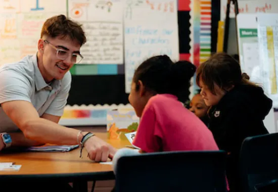 teacher working with three students