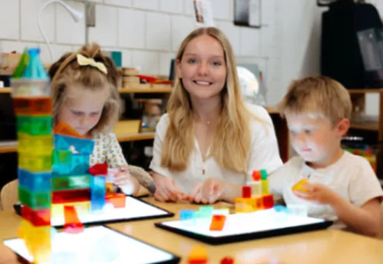 Teacher working with children in classroom.