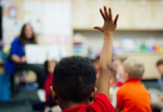 Child raising hand.