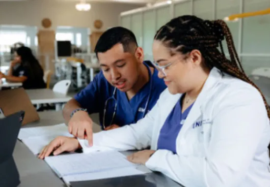 Two health care students working on project.