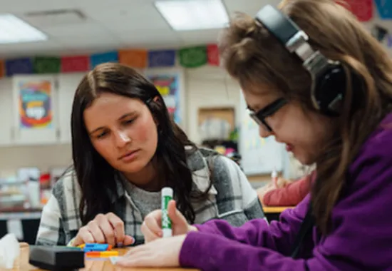 Teacher working with a student.