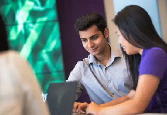 Students working together on laptop.