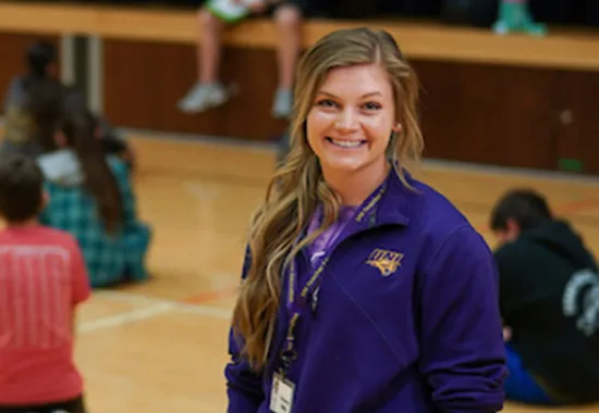 PE teacher standing in a gym