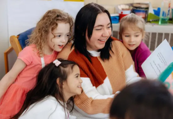 Teacher reading to young students.