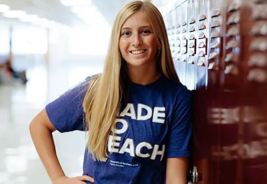 teacher standing in school hallway