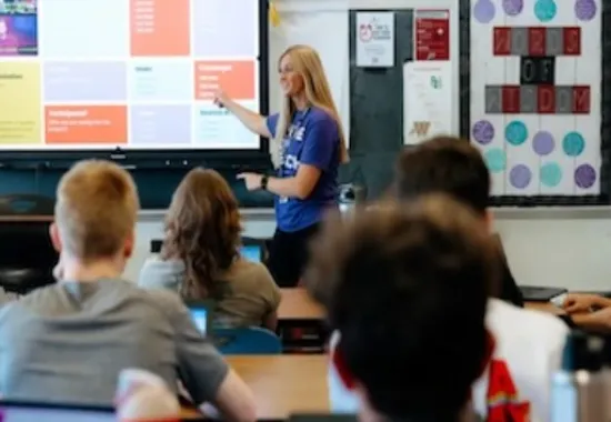 Girl teaching in front of her peers.