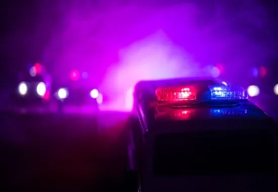 Police headlights in the dark.