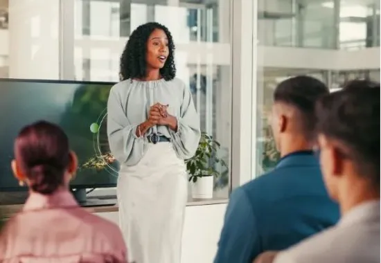 A woman talking in front of her colleagues.