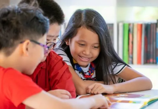 Three students reading together.