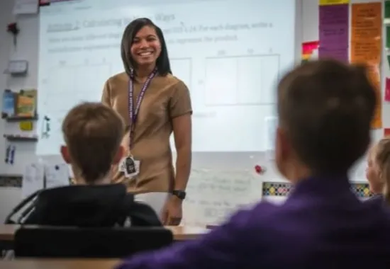 Teacher standing in front of her students.